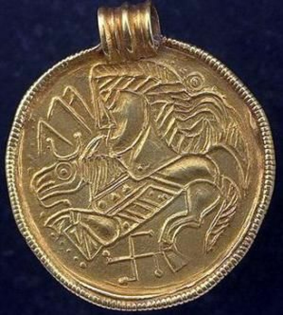 A typical Scandinavian gold braided bracteate with a figure of a horse and reverse swastika at the bottom. The runes on the bracteate say Alu. The bracteate is from the time around to the climate disaster. The swastika is an ancient symbol in many cultures, including in Scandinavia. This bracteate was found in Sweden.