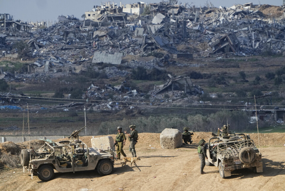 Israeli soldiers at a position near the bombed-out Gaza Strip on Friday. The country is accused of genocide by South Africa, but strongly denies it.