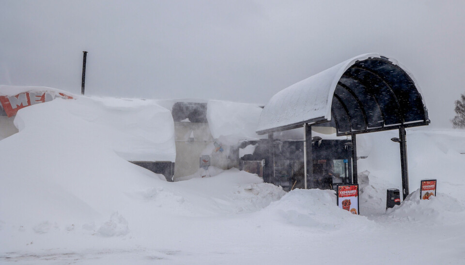 Strong wind and snow have made this grocery store in Kristiansand in southern Norway barely visible.