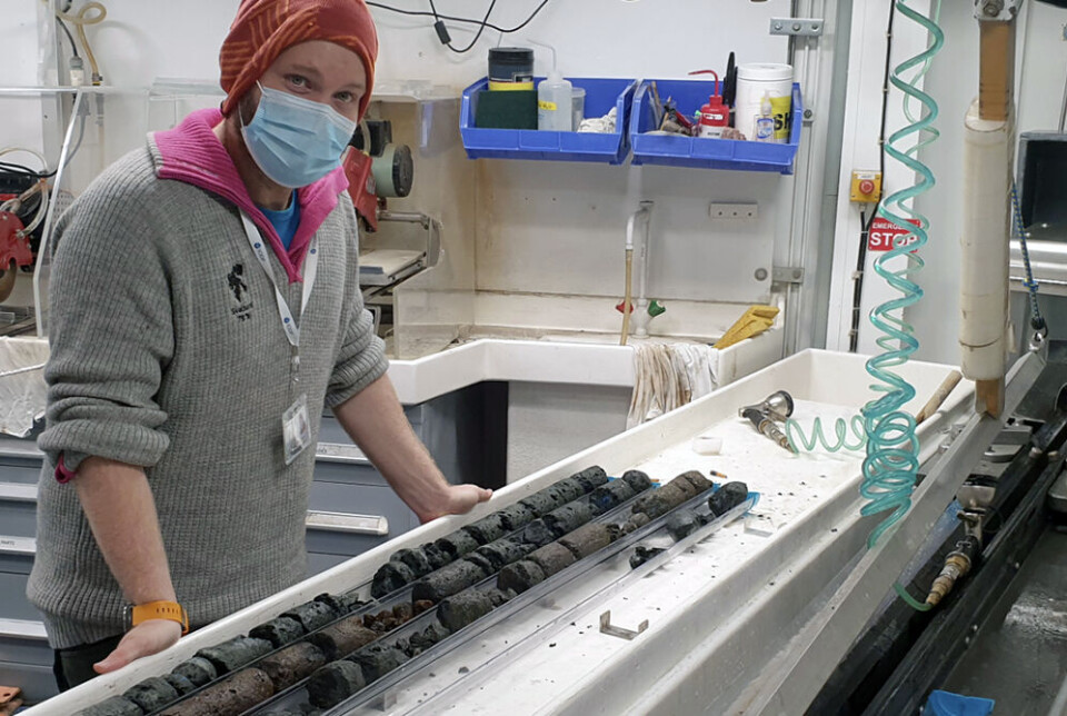 Researcher Peter Betlem with core samples from the Kolga Heights before they are split in two.