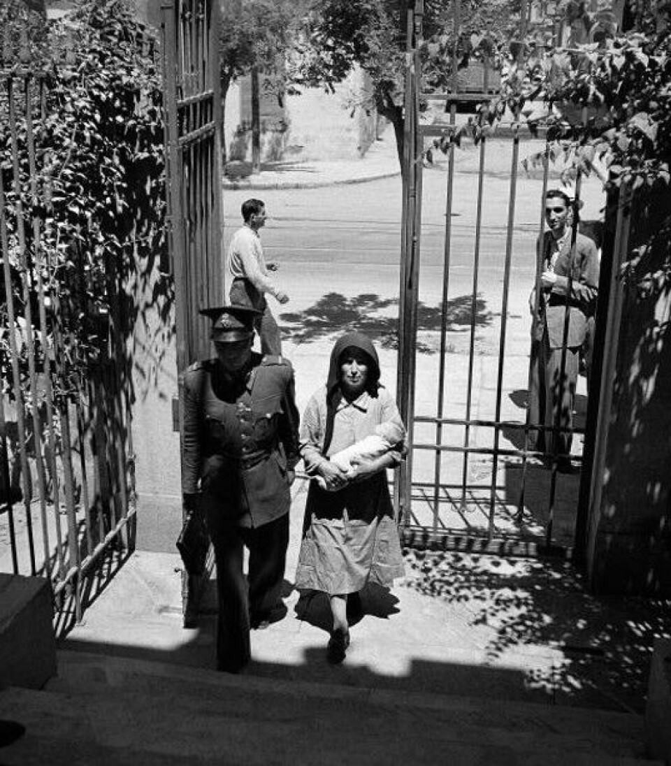 A woman delivers a child to a hospital for orphans in Athens.