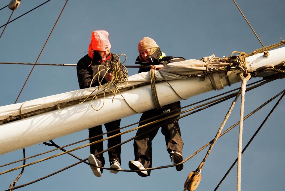 Two young people rig sails on the schooner Christian Radich. Along with 40 other young people, they learn new skills and to work together. They are part of a scheme for young people who are at risk of being excluded from obtaining a full education or a meaningful job.