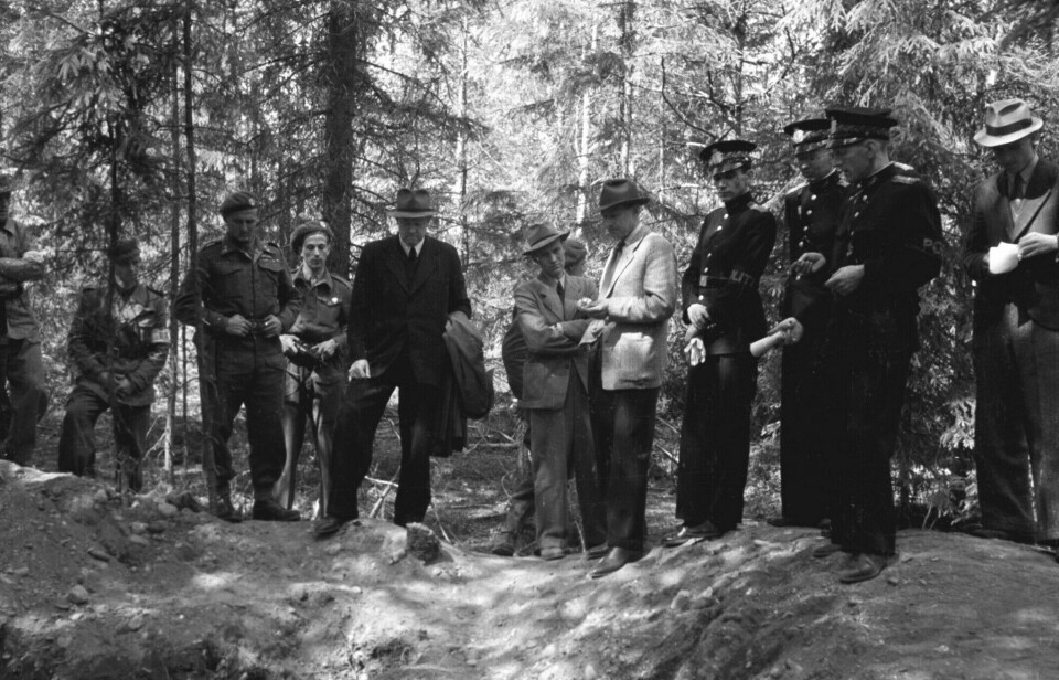 Norwegian and German Nazis were brought out of prisons to exhume the bodies of executed prisoners. Others were forced to watch. Here, Vidkun Quisling, the head of the Norwegian national socialist party National Gathering, is forced to watch the exhumations in June 1945.