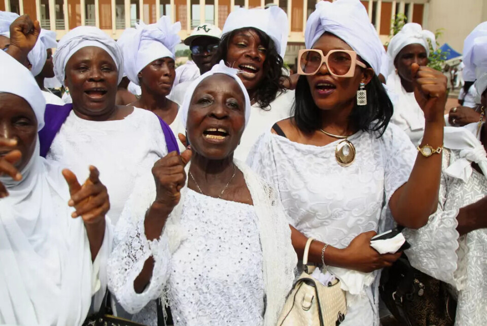 Women sing and dance in celebration of International Women's Day in a neighbuorhood near Monrovia, Liberia, March 8th, 2024. Women sing and dance in celebration.