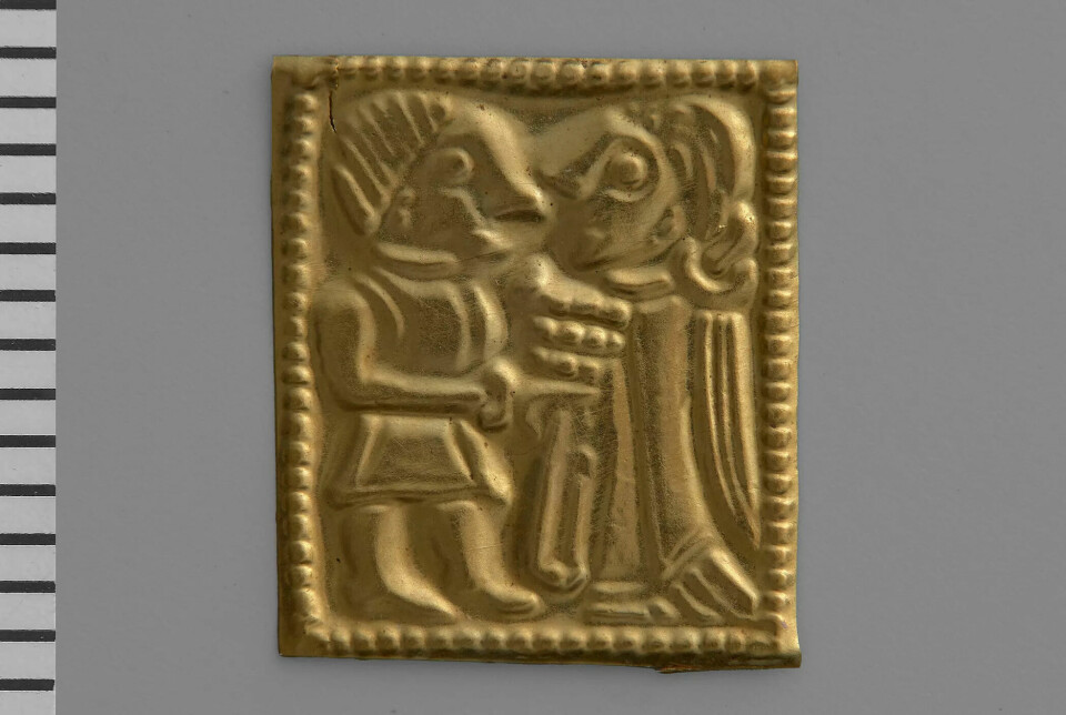 A close up of a gold foil figure showing a man and a woman.