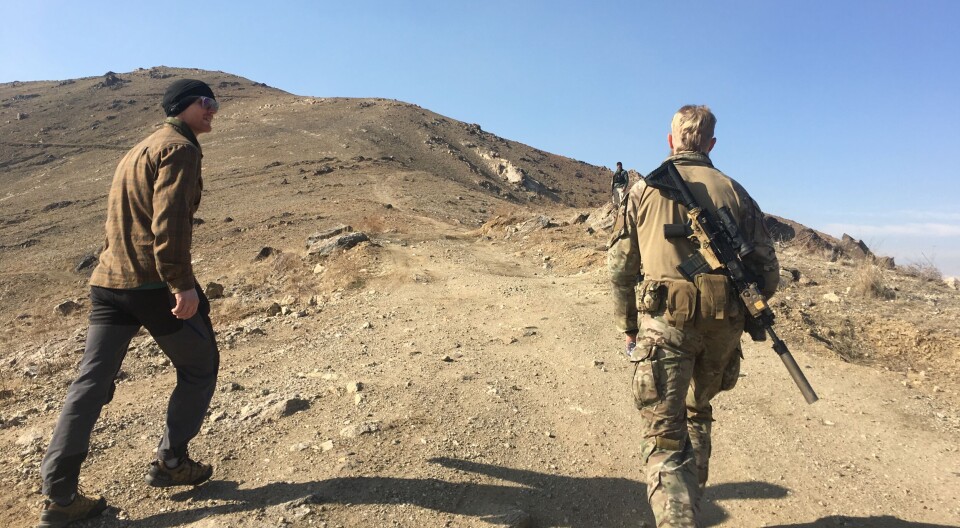 Lieutenant Commander and military psychologist Andreas Espetvedt Nordstrand and a Navy SEAL on their way up to patrol Mentor Hill outside Kabul.