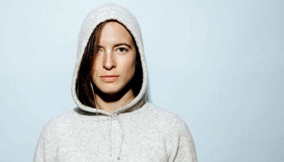 The image used as a starting point to create the AI-generated illustration above. Portrait photo of a woman in a light hoodie.