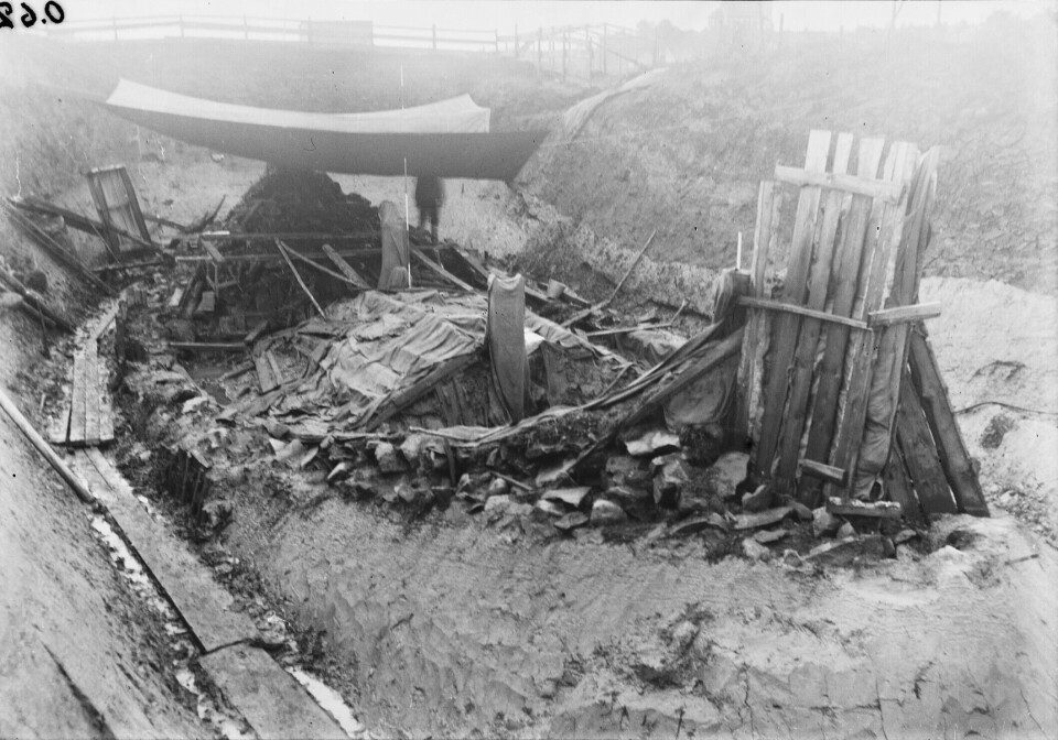The Oseberg Ship, as it appeared during excavation in the early 1900s. The burial chamber, where the textiles were found, can be seen in the middle of the ship.