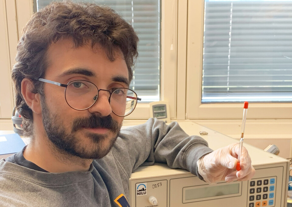 Engineer Sam Celentano and a Tekran measuring instrument. Inside the Tekran instruments are quartz tubes like the one he is holding up. They contain a small capsule of compressed gold pellets that are used to capture mercury from the air.