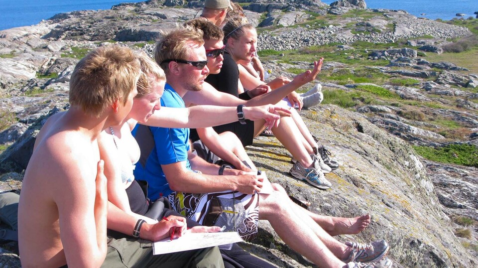 The researcher explains that there was also a divide between teachers who were very curious about using new technology and those who felt it undermined students' skills, such as map and compass reading. Six students on the mountain talking together.