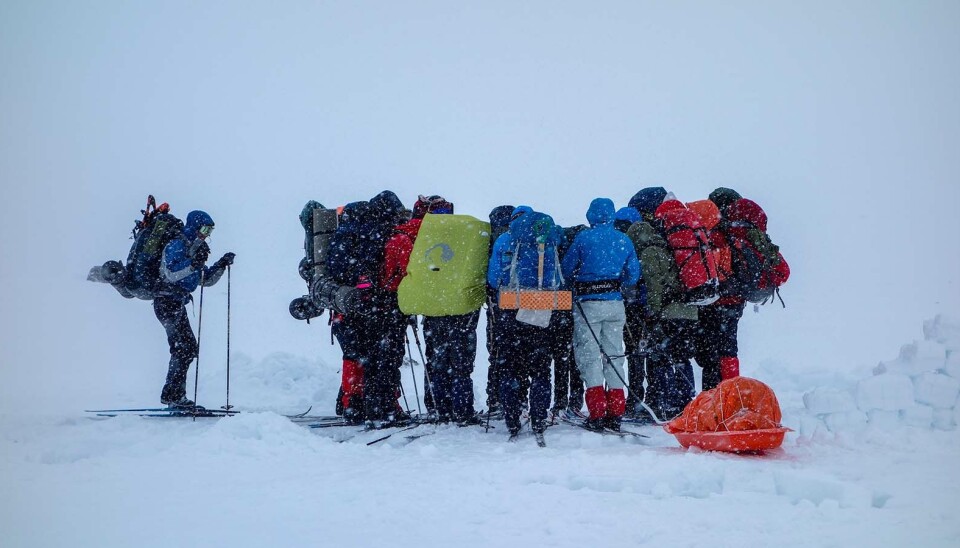 Is this really a good moment to pull out your phone? Students on a trip in a winter snowstorm.