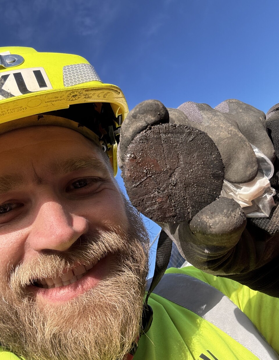 Field archaeologist Thomas Kjær with the game piece he found during the excavation.