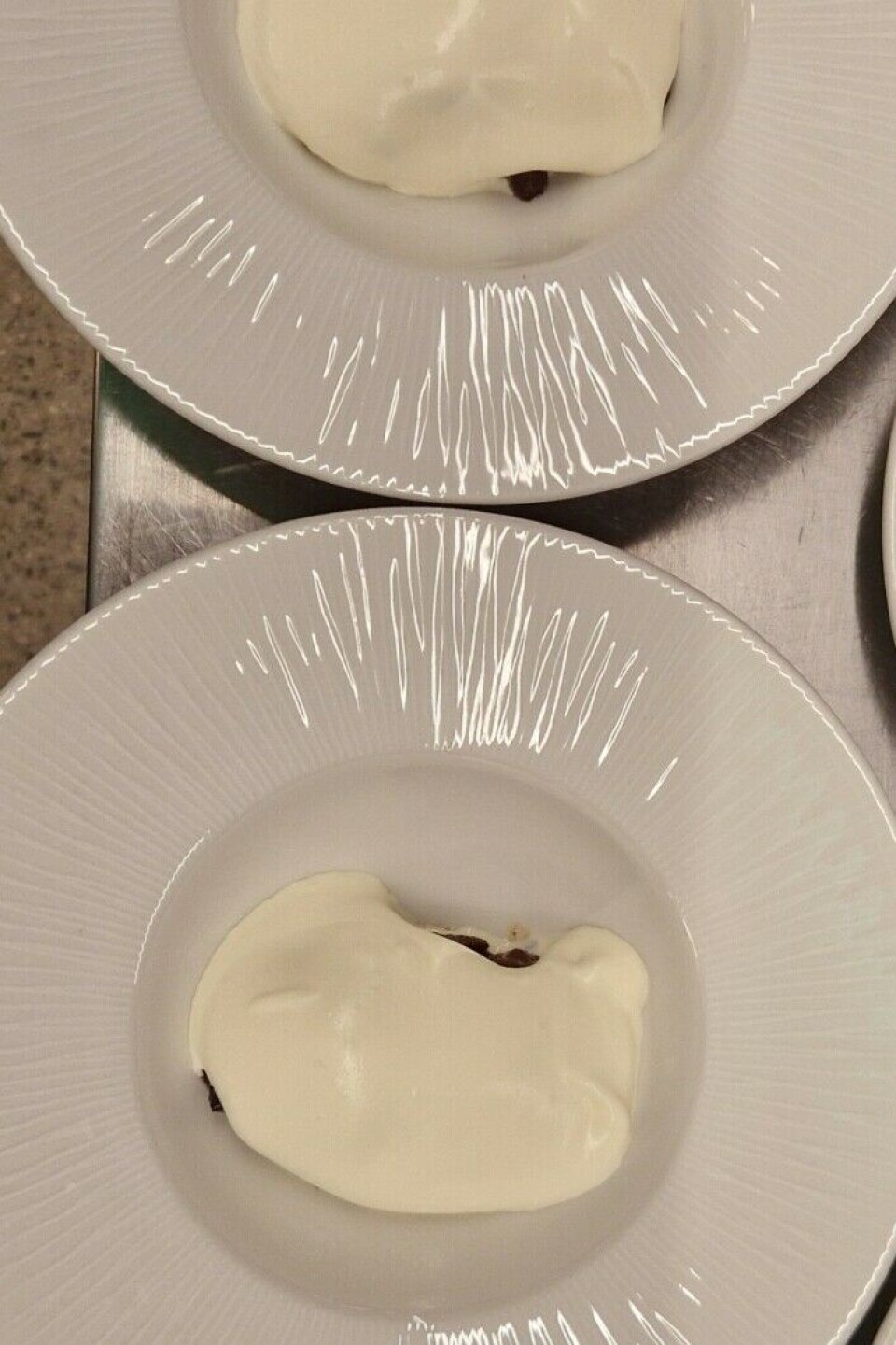 A dollop of whipped cream on prune compote.
