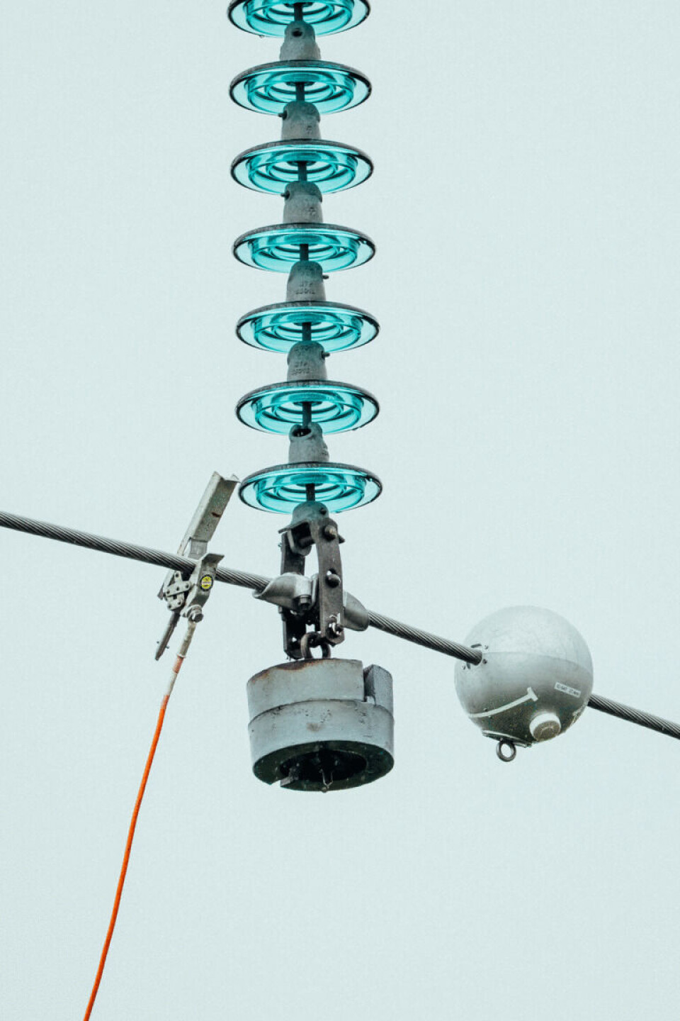 A drone installs the Neuron sensor node on a power cable.