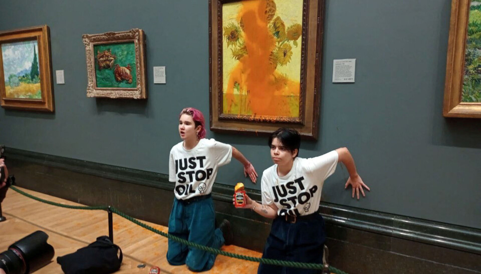 Activists from Just Stop Oil glue their hands to the wall after throwing soup at a Van Gogh painting.