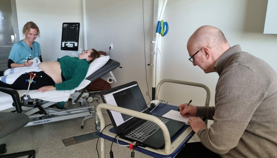 Torgrim Lie takes notes while the laptop receives images from the ultrasound machine.