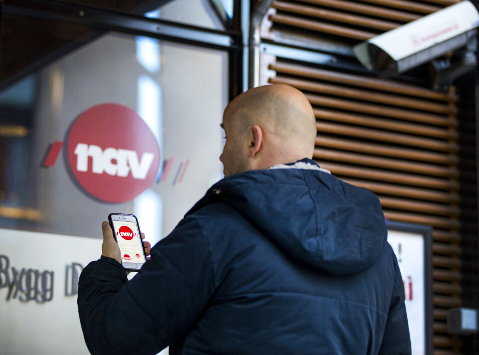 Stefan Schmager investigated how citizens and employees responded to a system that used artificial intelligence for following up individuals on sick leave. En mann utenfor bygg med et NAV-skilt.