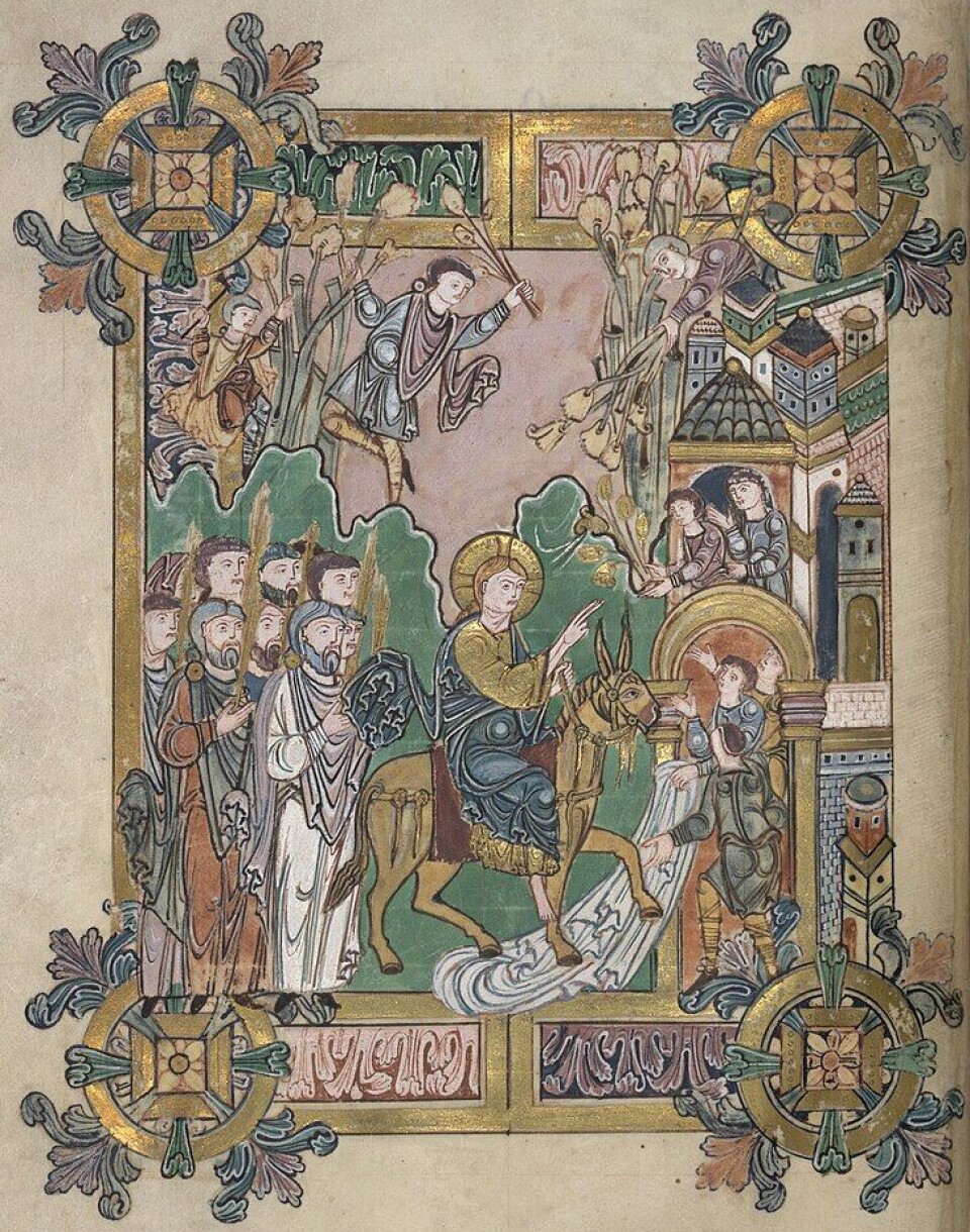 Foliage frames this depiction of Jesus' entry into Jerusalem on Palm Sunday, from the Benedictional of St Æthelwold.