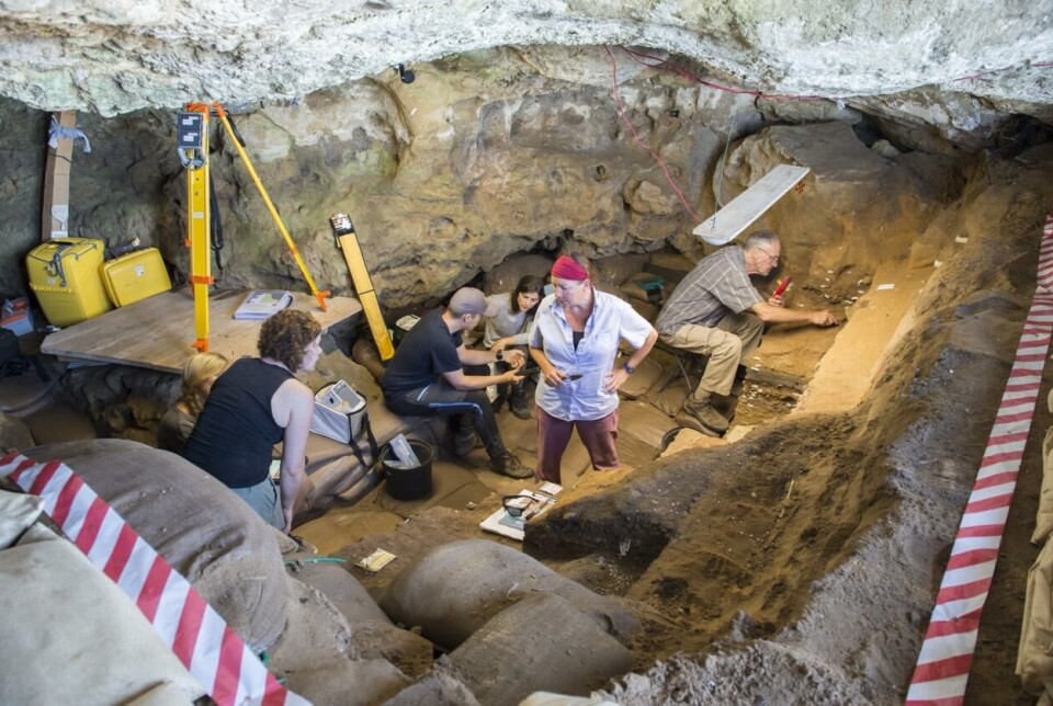 Inside Blombos Cave. Karen van Niekerk stands in the centre, while Christopher Henshilwood is excavating on the right.