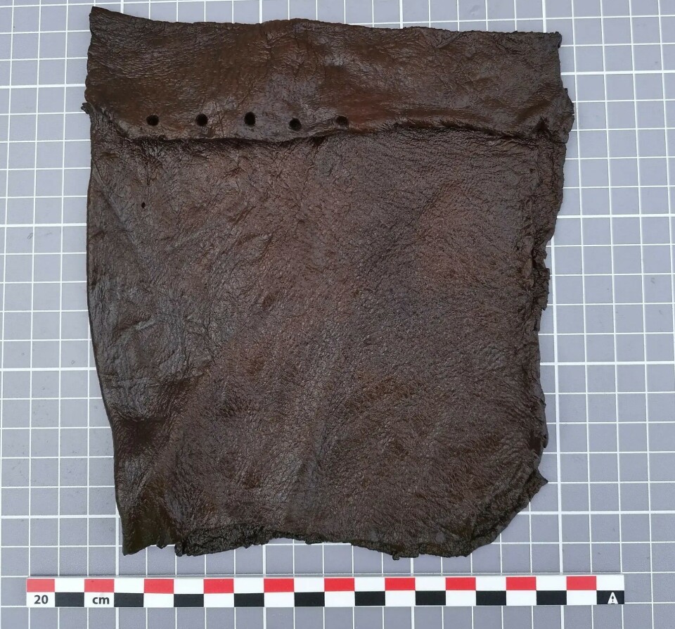 A square bag with a flap. The holes in the flap may have served as a closing mechanism, or perhaps they were decorative.