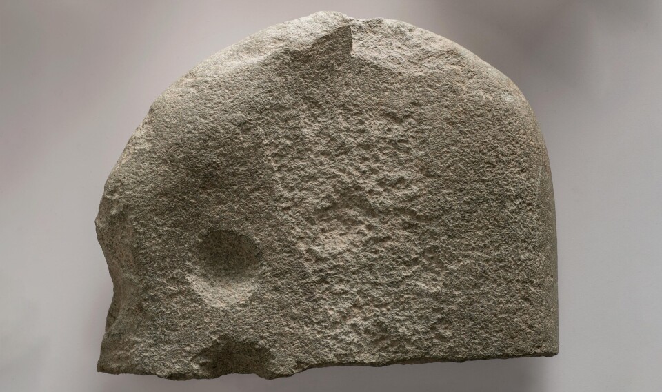 Petroglyph stone with a pecked foot outline with toes and cup marks. It was found in the burial cairn.