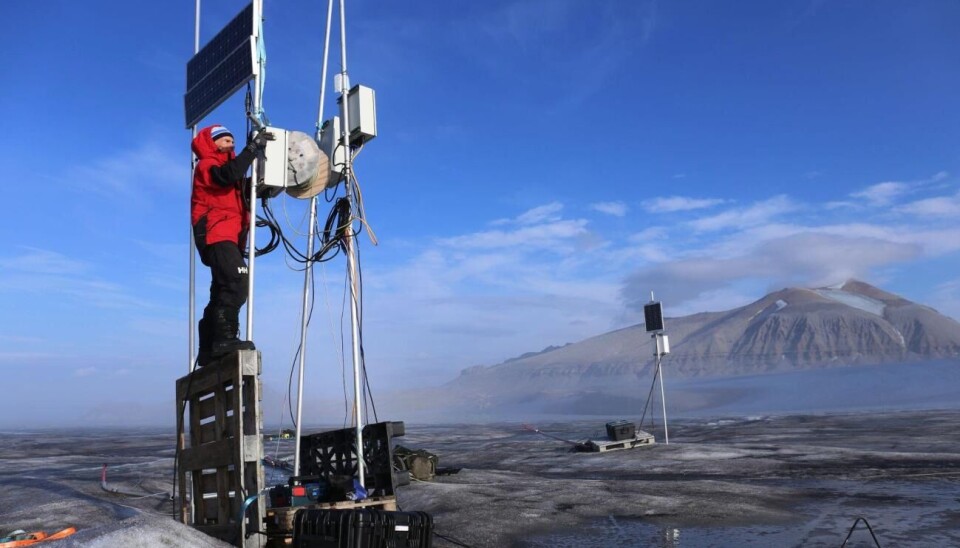 Researcher Thomas Vikhamar Schuler is seen here inspecting an instrument on top of a glacier during the summer of 2024. The devices stood much higher than expected because so much ice had disappeared.