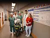 Staff pose in a hospital corridor with a bicycle equipped with emergency equipment.