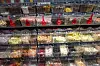 Rows of pick-and-mix sweets in clear bins with red scoops.