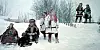 Sámi wedding group in colourful winter dress standing in deep snow at Kautokeino.