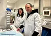 Man and woman in white lab coats working in a lab