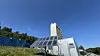 Solar panel array beside industrial buildings under a clear blue sky