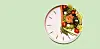 A plate shaped like a clock with salmon and vegetables on a light green background