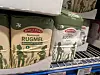 Rye flour bags lined up on a metal supermarket shelf.
