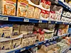 Shelves stocked with assorted oat and grain products in a supermarket aisle