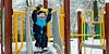 Young boy playing at an outdoor playground in winter.