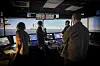 People in a ship bridge simulator during a cybersecurity training session.