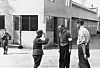 Black-and-white scene of men standing outside the Raufoss munitions factory building in 1945.
