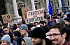 Crowd in Budapest rallying for Central European University with protest signs and EU flag.
