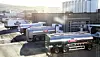 Tine-branded milk tankers parked outside a dairy processing plant in Norway