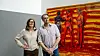 Two people stood in front of a large painting