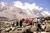 Trekking group hiking over rocks on Mount Kilimanjaro’s Machame route