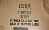 Wall sign indicating entrance to a clean zone through shower baths