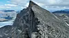 Jagged mountain ridge in Sarek National Park, northern Sweden, under a cloudy sky.