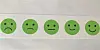 Row of five green emoji faces from sad to happy on a white background.