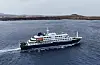 Drone view of the MV Hondius cruise ship travelling across open water near Praia, Cape Verde.