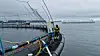 Worker on a sea cage at the Tristein Atlantic salmon farm with monitoring equipment and calm water nearby.
