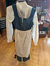 Vintage-style maid uniform displayed on a mannequin stand indoors.