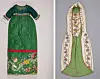 Two green traditional garments with embroidery and decorative borders hanging side by side.