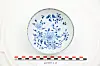 Blue-and-white decorative plate with floral and bird designs on a white display background.