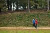 Two people running on a trail outdoors